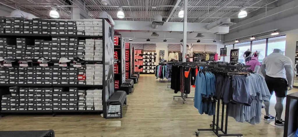 New Balance Factory Store with various promotional sneakers