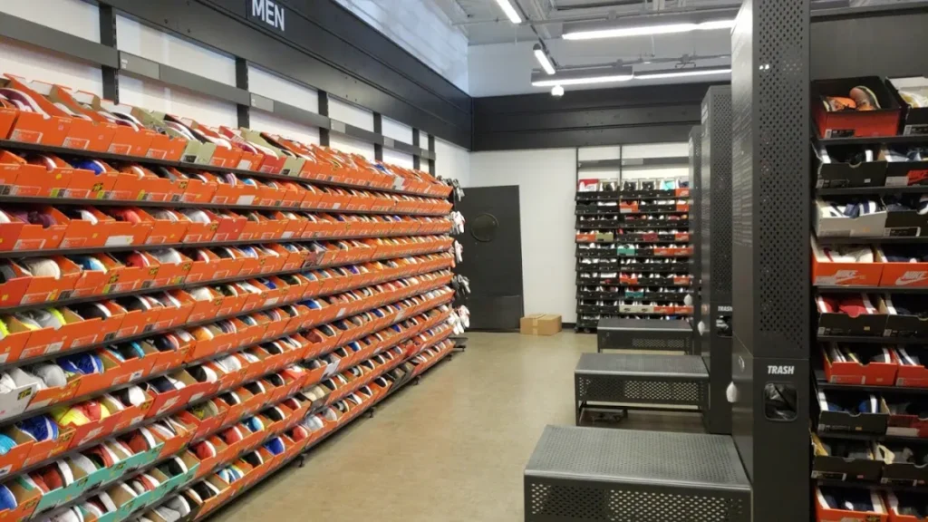 Shelves at Nike Clearance Store with various pairs at outlet prices