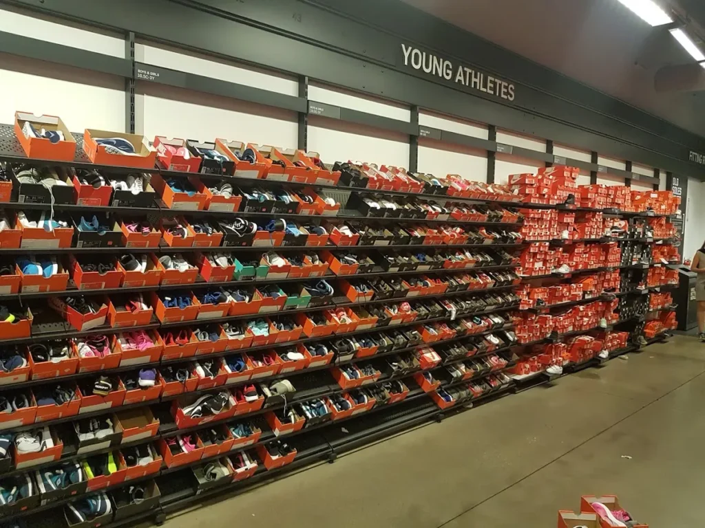 Nike Factory Store with various sneakers at discounted prices