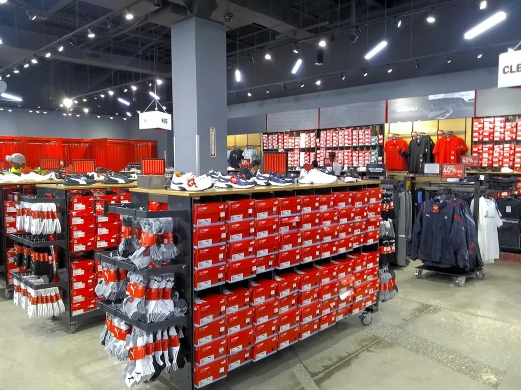 Inside view of the PUMA store with various sneakers on sale