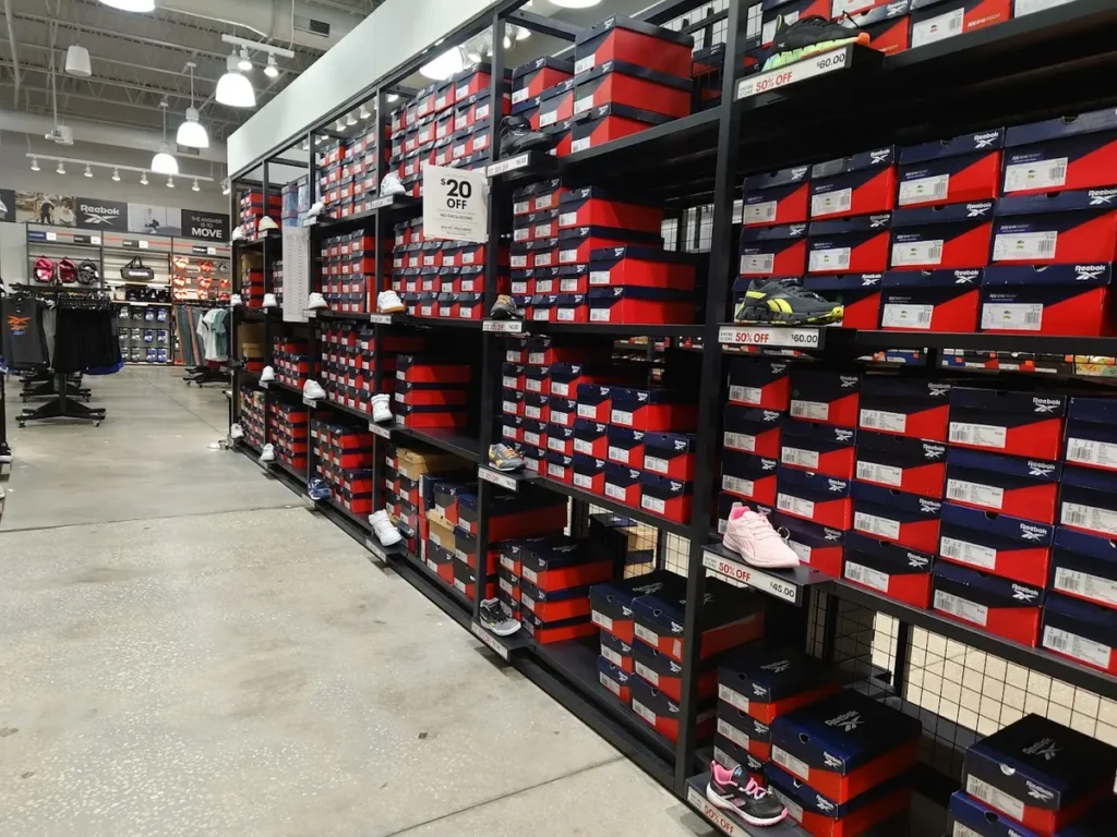 Inside view of the Reebok store with various sneakers on sale with 20% off