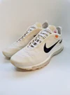 Cream Nike sneakers with black Swooshes