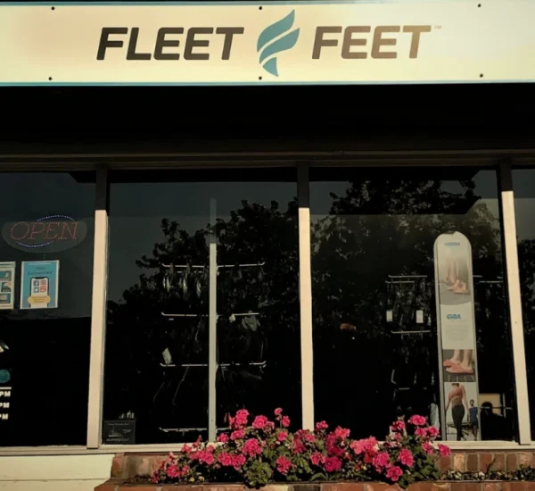 Fleet Feet storefront in Vacaville, with its sign above glass entrance doors and display windows.