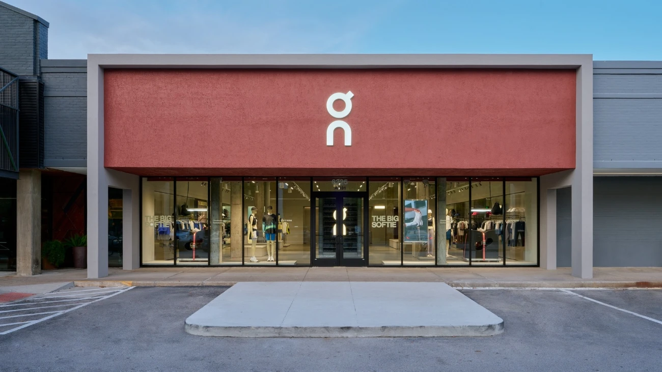 On storefront with a terracotta facade and illuminated shoe displays
