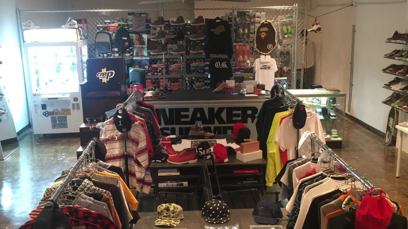 Sneaker Summit interior with clothing racks, a checkout counter and shoe shelves
