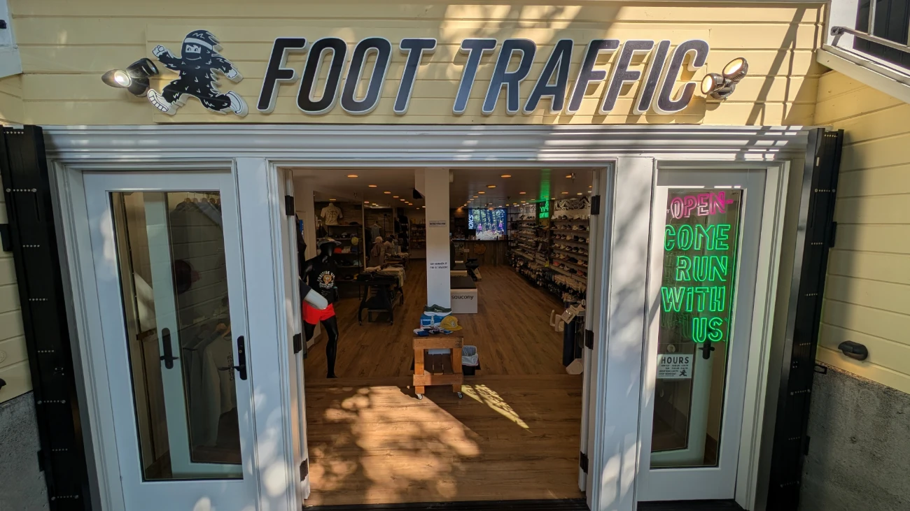 Foot Traffic entrance with open white doors and running shoes visible inside.