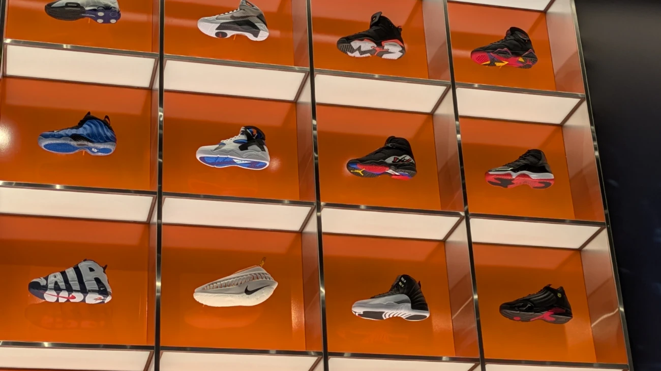 Nike sneakers in orange-backed display cubbies.