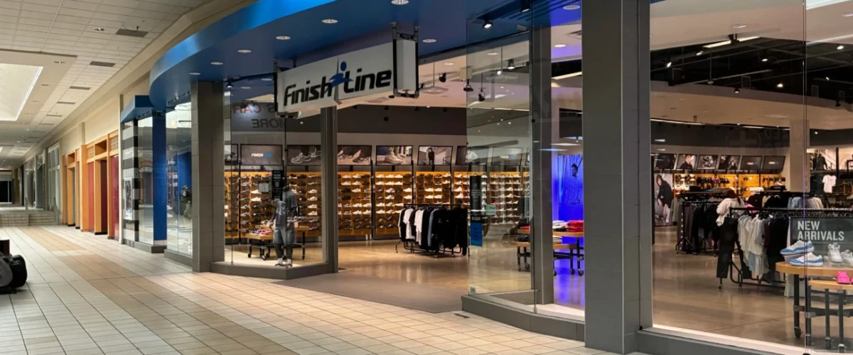 Shiekh storefront at Meadows Mall in Las Vegas, with a blue illuminated sign and shoe displays inside.