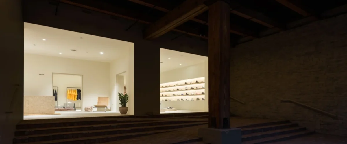 Sole Classics interior in Columbus, with wall-mounted sneakers, clothing racks and a rug beneath a display table.