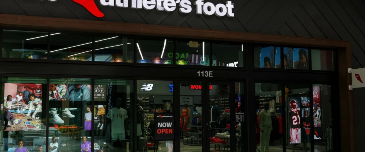 Union storefront with white lettering on a black awning, the number 110 and glass windows displaying clothing.